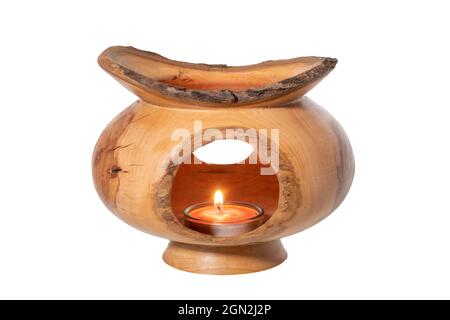 Openwork turned decorative object with a candle in a glass insert, isolated on white Stock Photo