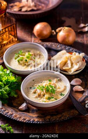 Vegan cabbage soup with oyster mushrooms with vegetables  on old kitchen table Stock Photo