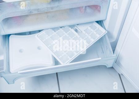 Ice cube maker in modern freezer with no-frost, houseold concept Stock Photo