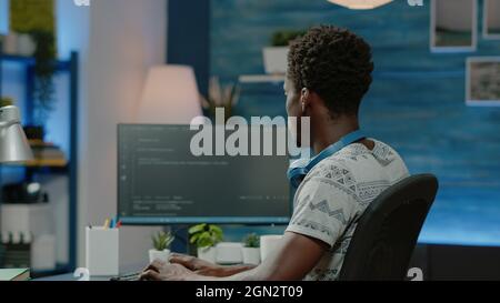 Person programming website firewall with codes on computer. Programmer coding web interface with binary code and network system for cybersecurity and protection. Coder designing server Stock Photo