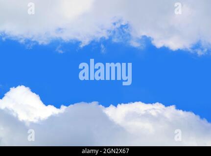 Vivid Blue Sunny Sky between White Clouds with Copy Space Stock Photo