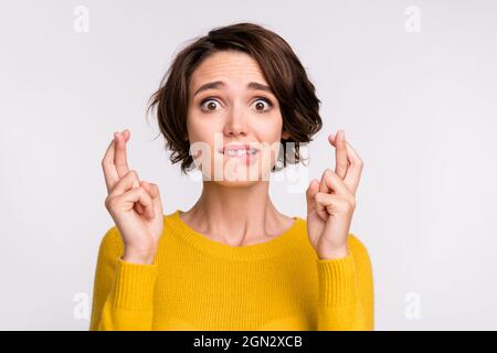 Photo of young girl bite lips teeth fear crossed fingers pleading wish ...