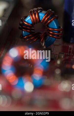 Close up of inductor copper coil on circuit board Stock Photo