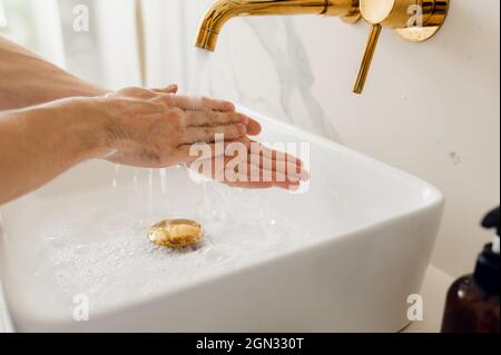 the man washes his hands thoroughly. Corona Virus Protection. modern bathroom Stock Photo