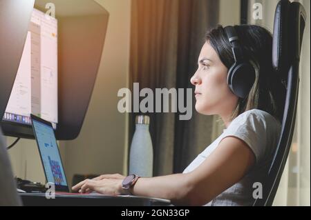 Working remote at home using laptop and big screen Stock Photo