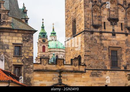 Church of Saint Nicholas in the Lesser Town, in foreground the walls of Mala Strana Bridge Tower, Prague, Czech republic Stock Photo