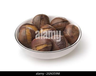 Roasted chestnuts on white plate isolated on white Stock Photo