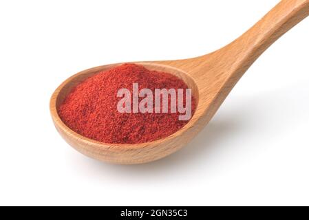 Red paprika powder in wooden spoon isolated on white Stock Photo