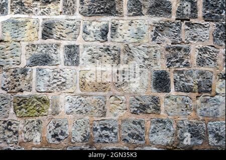 Wall background with different colored natural stones. Stock Photo