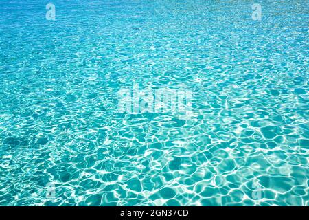 Abstract background of glowing sea aqua with blue waves on sunny day in Ibiza Spain Stock Photo