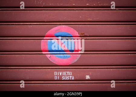 Parking prohibited steet signs on old roller shutter in italy street Stock Photo