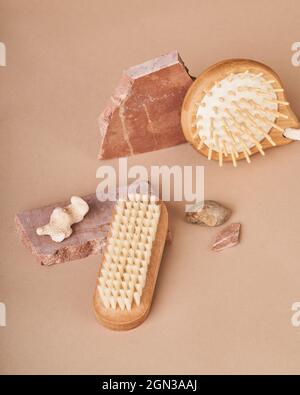 From above of eco friendly brushes and natural soap bars with pumice stone and mineral on beige background Stock Photo