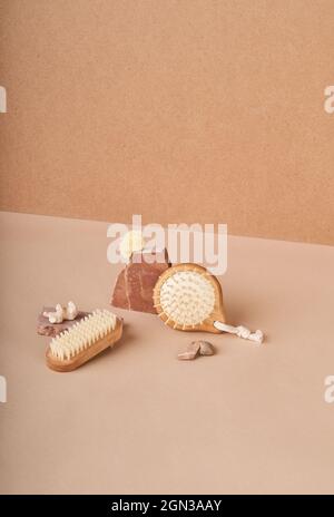 From above of eco friendly brushes and natural soap bars with pumice stone and mineral on beige background Stock Photo