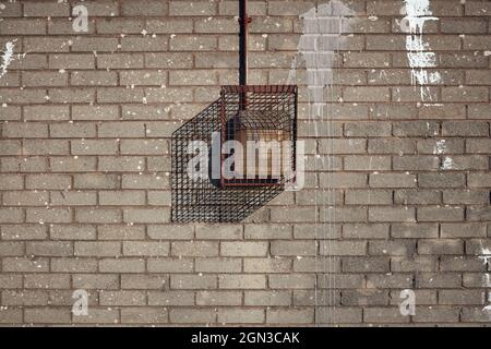 Grey brick wall with vandal proof light Stock Photo
