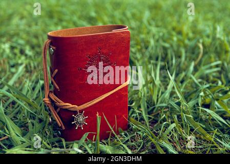 brown leather notebook on a background of green grass Stock Photo