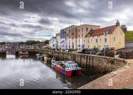 The picturesque harbour and coloured buildings of St Andrews in Fife on the east coast of Scotland. Stock Photo