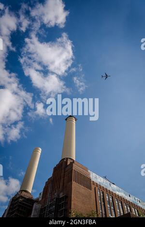 Airplane flying over Battersea Power Station, London, England, UK Stock Photo