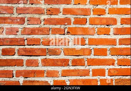 Old weathered red brick wall as background Stock Photo