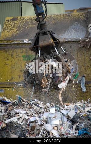 Hydraulic grabber machine being used at a materials recovery facility ...