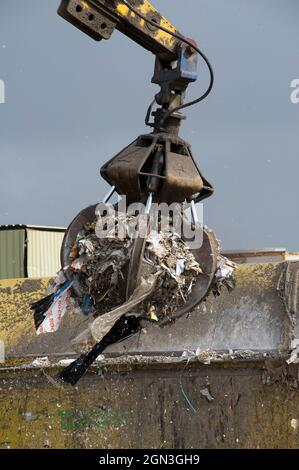 Hydraulic grabber machine being used at a materials recovery facility ...