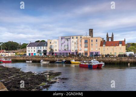 A fishing boat leaving the picturesque harbour of St Andrews in the East  Neuk of Fife on the Scottish coast. Stock Photo