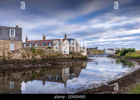 Reflections in Kinness Burn in St Andrews, with the harbour and cathedral ruins in the background, East Neuk, Fife, Scotland. Stock Photo