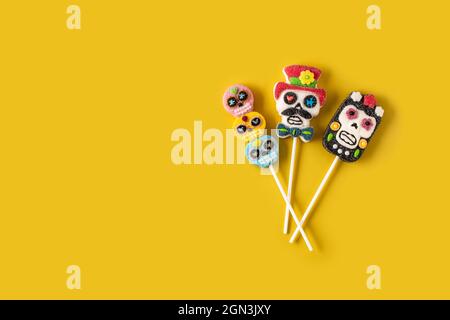 Candy skull lollipops on yellow background Stock Photo