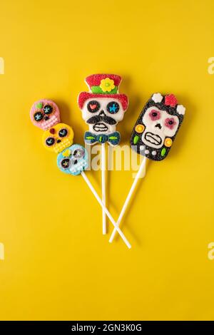 Candy skull lollipops on yellow background Stock Photo