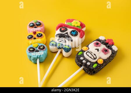 Candy skull lollipops on yellow background Stock Photo