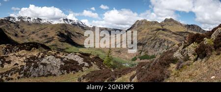 Panoramic view from the lower slopes of Side Pike looking up Mickleden. Crinkle Crags, Bow Fell and the Langdale Pikes all in view. Stock Photo