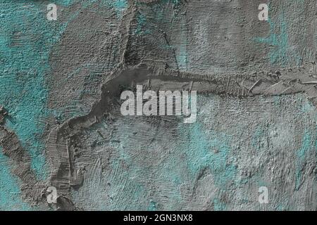 The texture of a gray with turquoise spots of a cracked cement wall with a smeared crack. Background. Stock Photo
