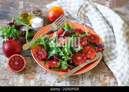 Super nutritious detox salad with red orange and mix of salads. Vegan diet. Diet food. Fitness nutrition. Stock Photo