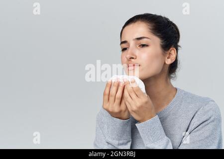 disgruntled woman runny nose cold health problems treatment Stock Photo