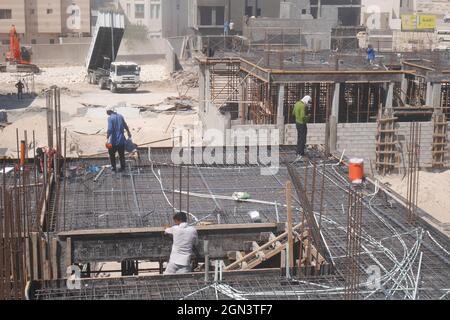 Asian construction workers working on a building, Kingdom of Bahrain Stock Photo