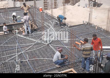 Asian construction workers working on a building, Kingdom of Bahrain Stock Photo