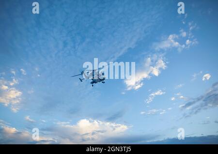 Dhruv, an advanced light helicopter developed by Hindustan Aeronautics Limited's, flies against the backdrop of a think layer of cirrus clouds. Stock Photo