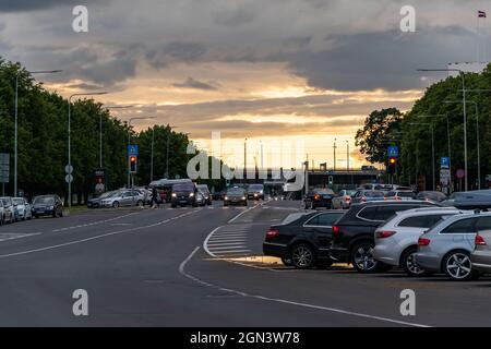 2020, July 11 - Riga, Latvia: Summertime. Road, parking and golden sunset in the city. Stock Photo