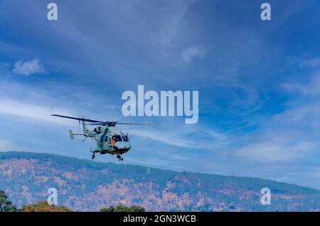 Dhruv, an advanced light helicopter developed by Hindustan Aeronautics Limited's, flies against the backdrop of a think layer of cirrus clouds. Stock Photo