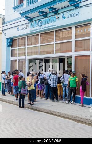 CAMAGUEY, CUBA - JAN 26, 2016: People are waiting in a queue at the telecommunication company ETECSA office in the center of Camaguey. Stock Photo