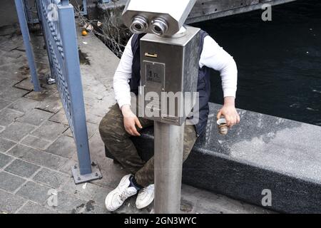 ISTANBUL, TURKEY - Mar 07, 2020: A closeup shot of an observation apparatus looking like a robot suit for a man sitting behind it in Istanbul, Turkey Stock Photo
