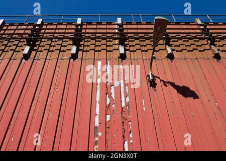 Old and rusty red industrial wall Stock Photo