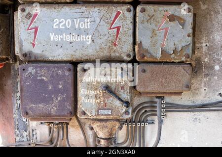 Old unused electric power distribution box close up shot on abandoned building Stock Photo