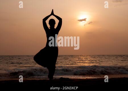yoga girl on the shore of the indian ocean