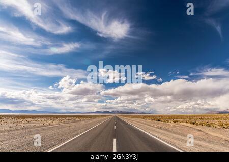 Centered road middle POV in a salt field. Salinas Grandes, Jujuy, Argentina. Symmetrical landscape photography. Stock Photo