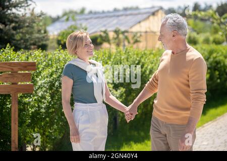 Happy mature married couple standing in the countryside Stock Photo