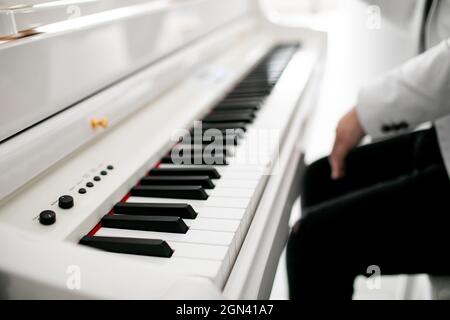 Close up of man hands piano playing. Male pianist hands on grand piano keyboard Stock Photo