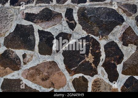 Tidy inlaid stone wall forming a decorative Stock Photo