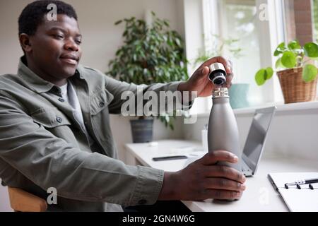 Thirsty Man In Office Opening Reusable Water Bottle For Drink Stock Photo