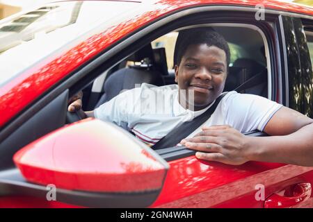 Portrait Of Young Man Looking Out Of Car Window Stock Photo