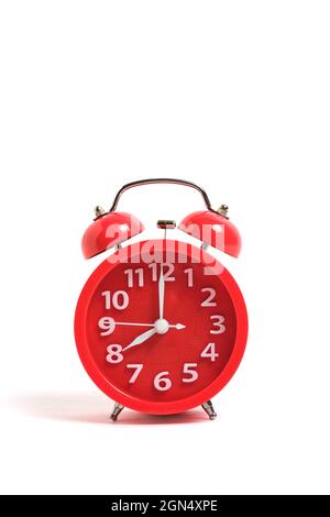 Red alarm clock isolated on a white background shows eight clock in morning Stock Photo